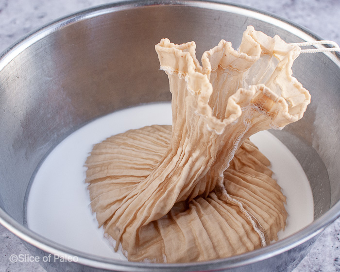 Homemade Unsweetened Coconut Milk squeezing out milk nut bag