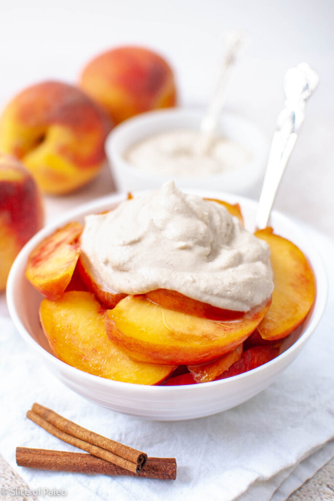 Fresh Peaches and Whipped Cream with Cinnamon served in a white bowl