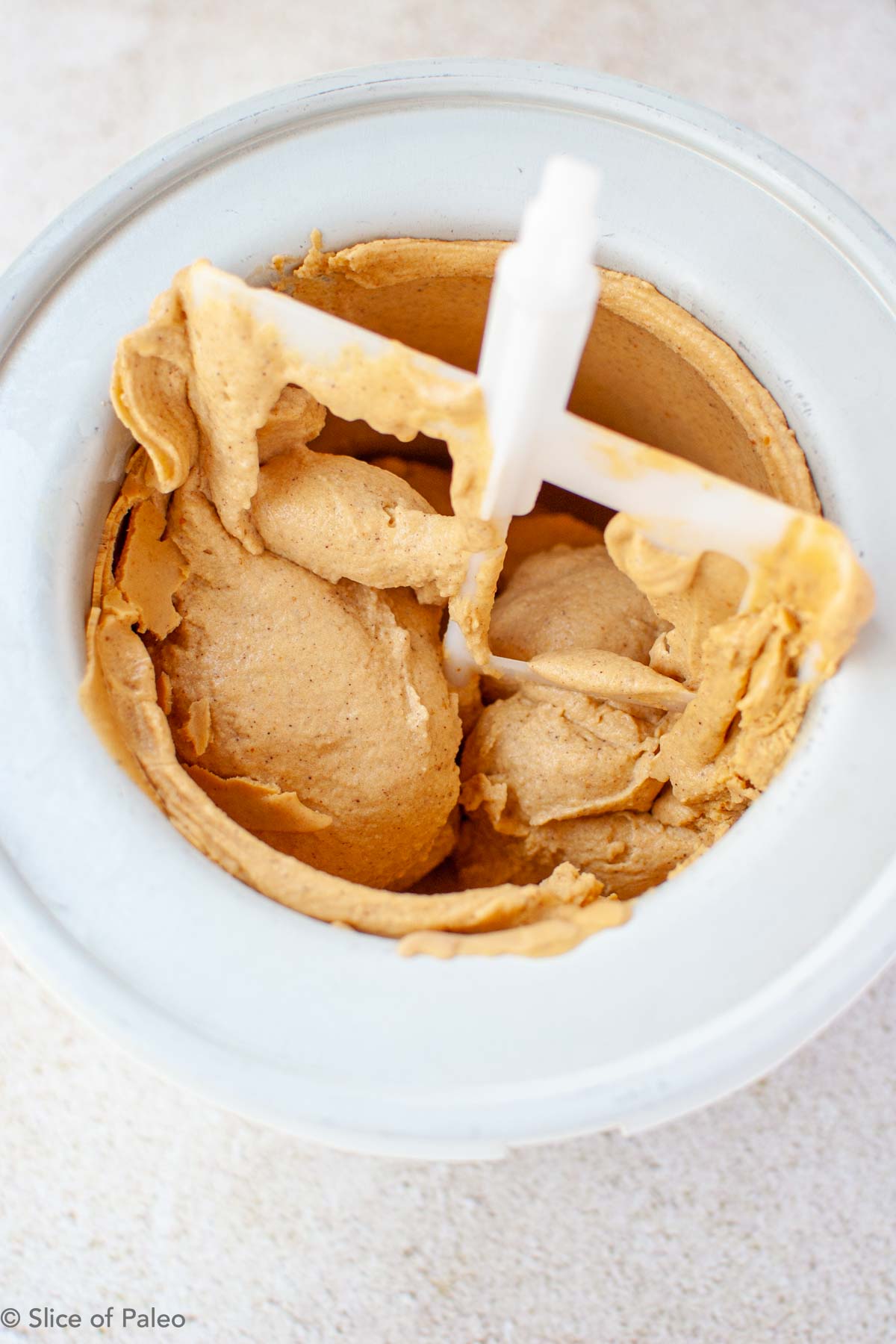 Paleo pumpkin ice cream churning in ice cream maker