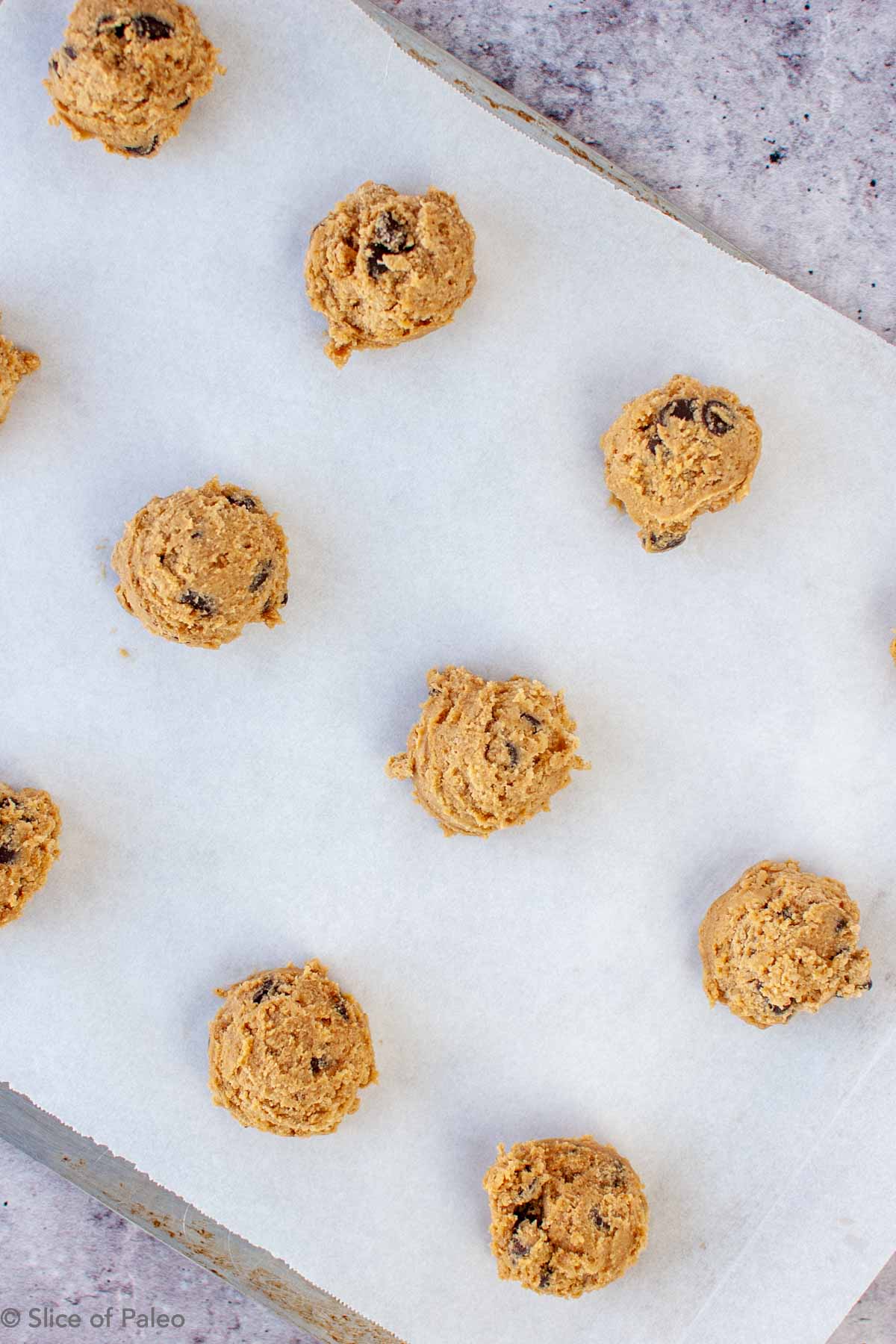 Paleo Chocolate Chip Cookies dough balls on a cookies sheet