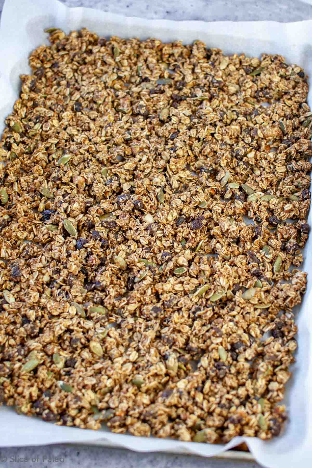 Pumpkin Granola with Maple Syrup on a baking sheet