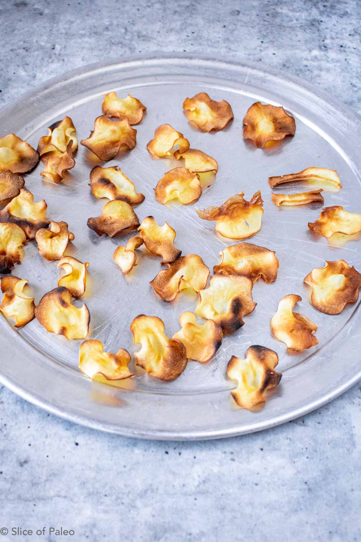 Baked Parsnip Chips cooling on a pan