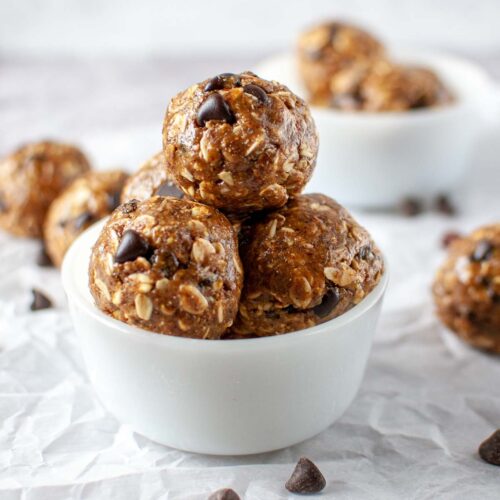 Almond Butter Energy Balls stacked in a white bowl