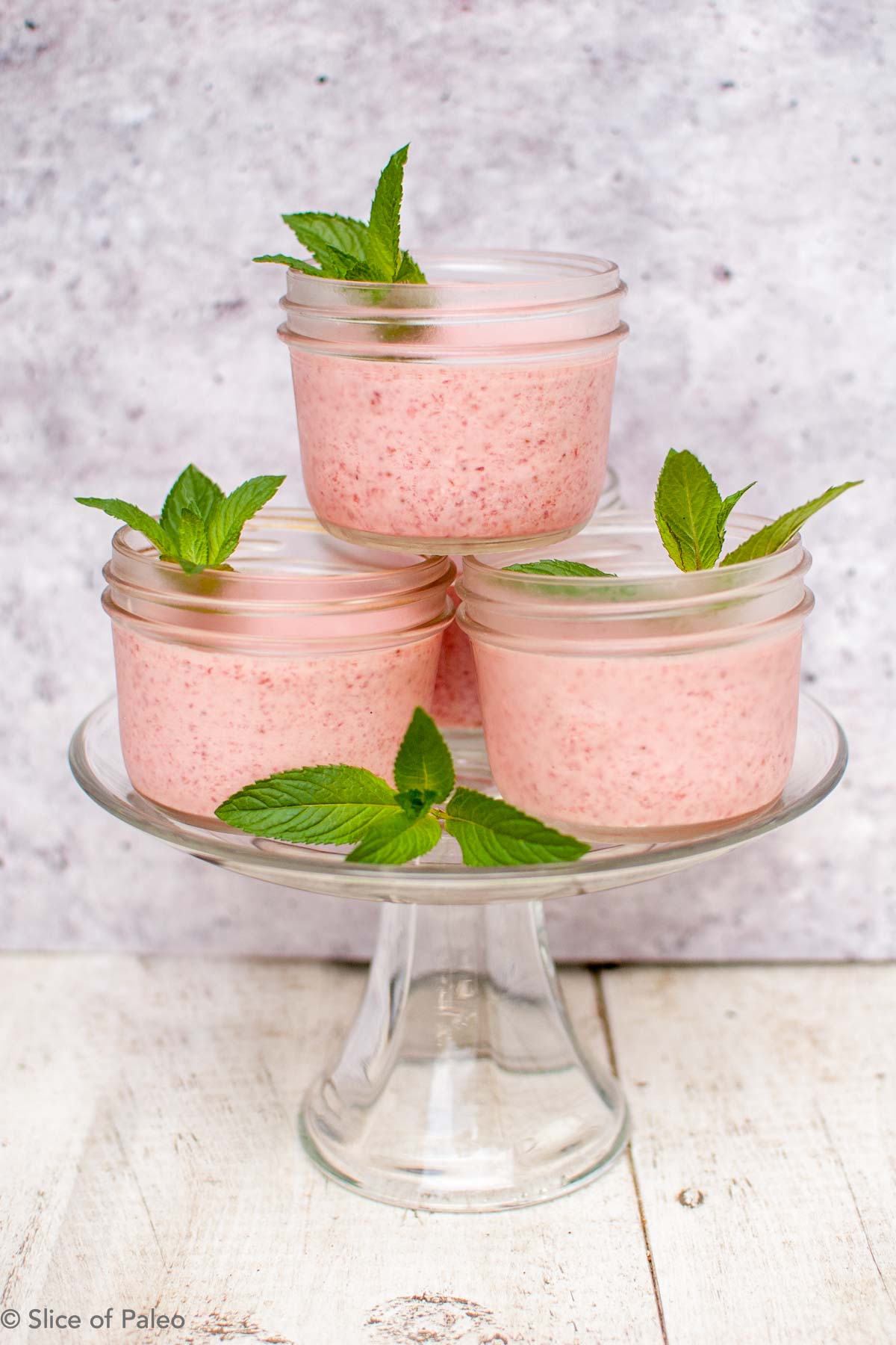 Paleo Strawberry Fool in ball jars stacked on a cake plate