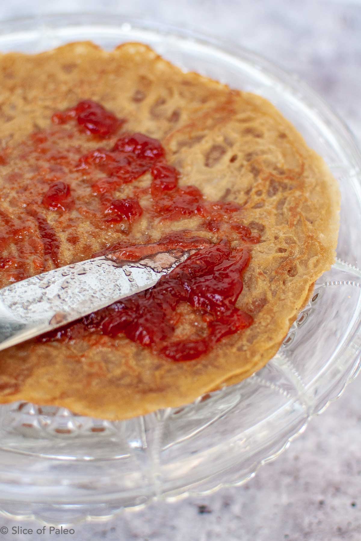 Putting together a Paleo Crepe Cake with jam