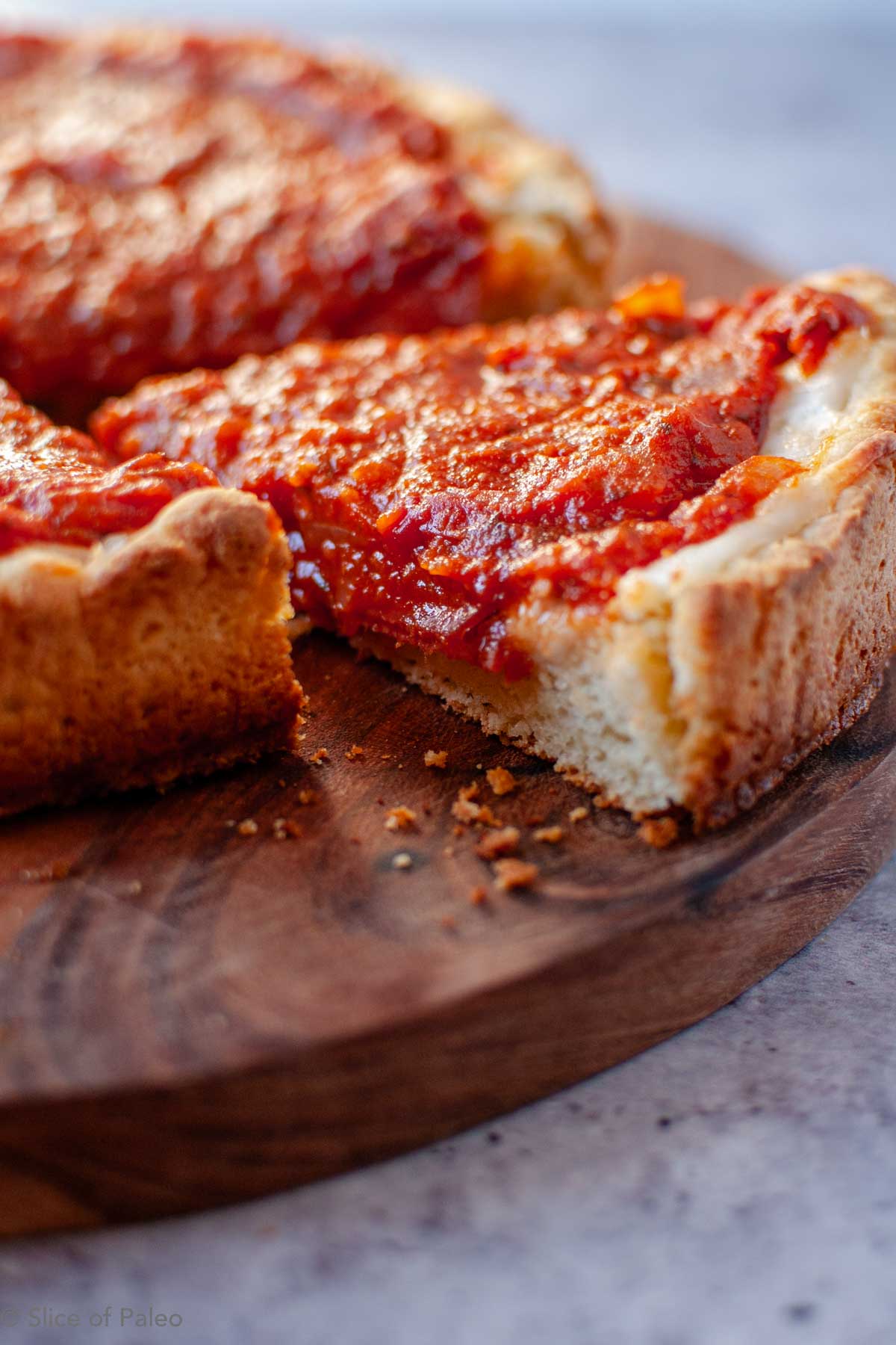 Paleo Chicago Style Deep Dish Pizza slice showing thick crispy crust.