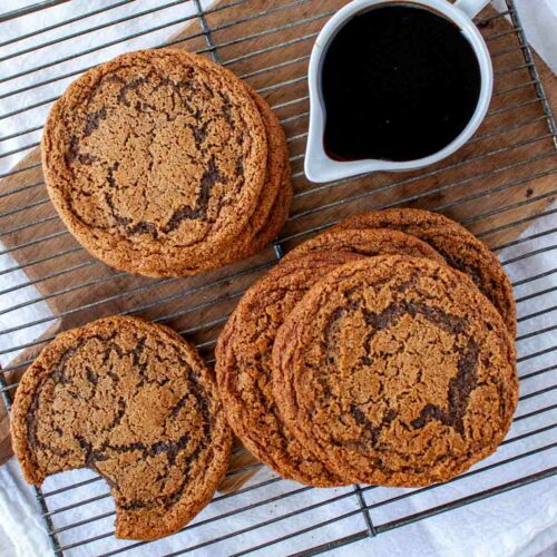 Paleo Molasses cookies stacked on a cooling rack.